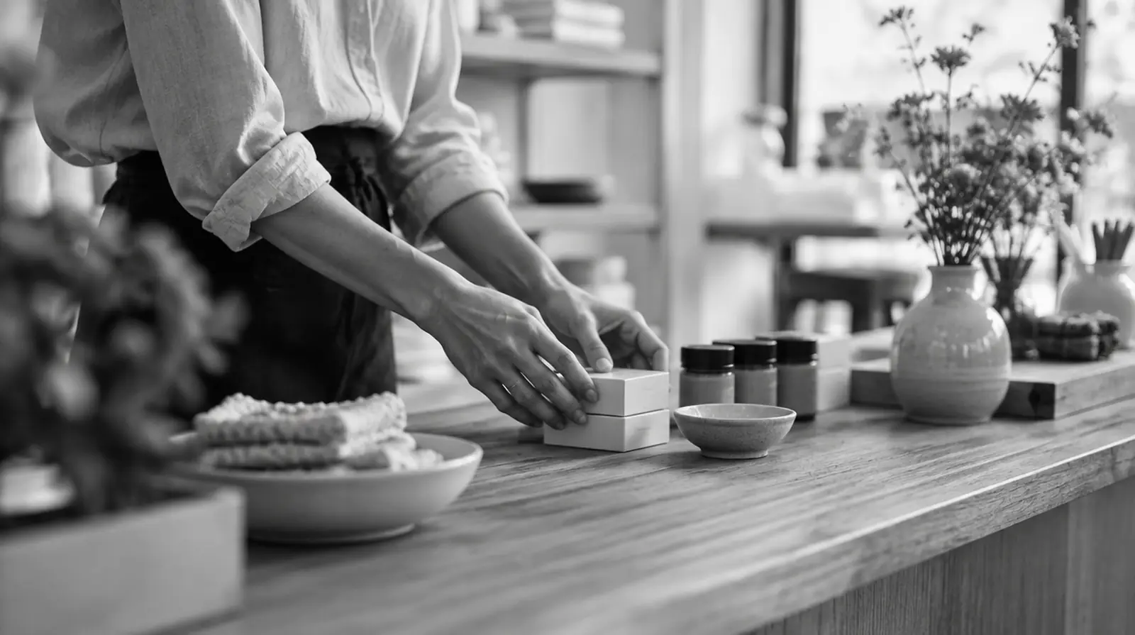 Small business owner arranging products on a shop counter